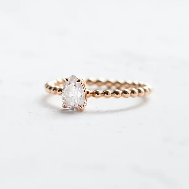 Gold engagement ring with beaded ball setting and pear moissanite BEAU Image
