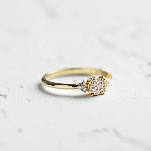 Angled view of the BOOGIE gold engagement ring with pavé moissanites