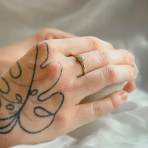 Gold BOOGIE engagement ring with pavé moissanites worn on a hand