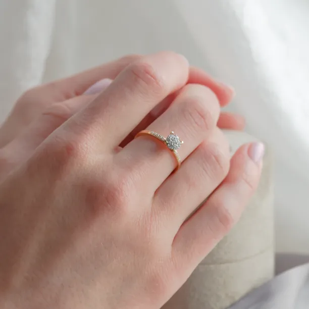 Pavé gold ring with moissanites worn on the hand