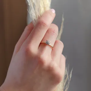 Pavé gold ring with moissanites worn on a finger