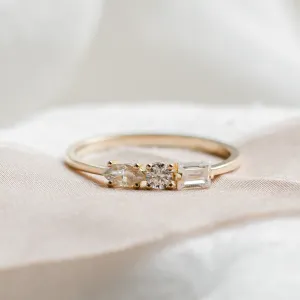 Close-up of AVELA gold ring with three differently shaped lab-grown diamonds
