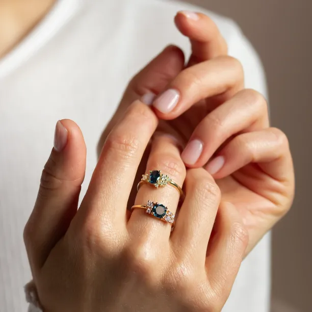 VAIANA gold rings with blue and white lab-grown diamonds shown worn on the hand
