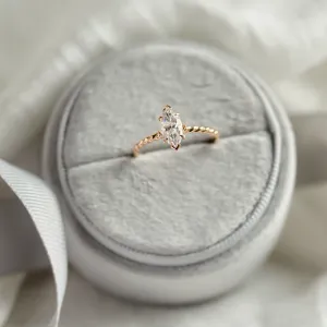 Angled view of the gold DAHLIA ring with marquise-cut moissanite