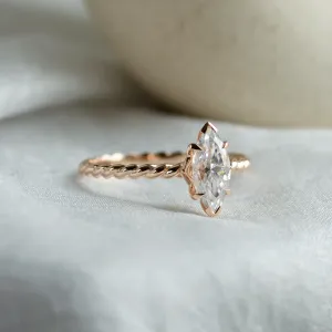 Close-up of the gold twisted rope ring with marquise-cut moissanite