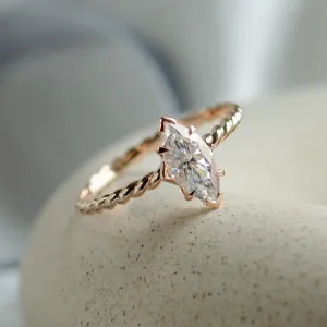 Close-up of the DAHLIA gold twisted rope ring and marquise-cut moissanite