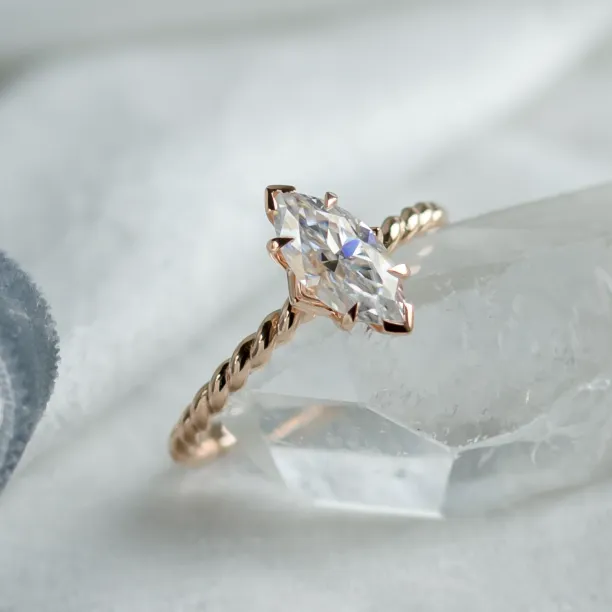 Close-up angled view of the DAHLIA ring with a marquise-cut moissanite