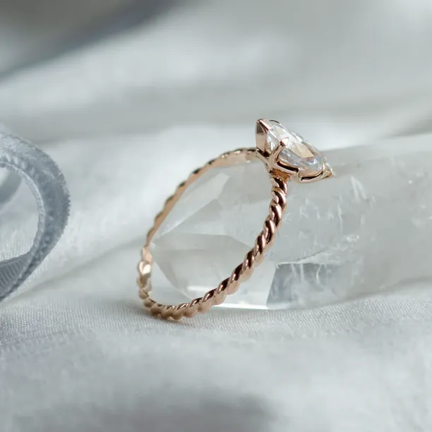Angled view of the gold DAHLIA twisted rope ring with marquise-cut moissanite