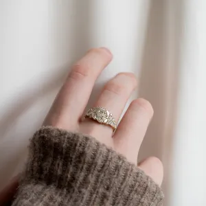 Lab grown diamond cluster ring worn on a finger, angled view