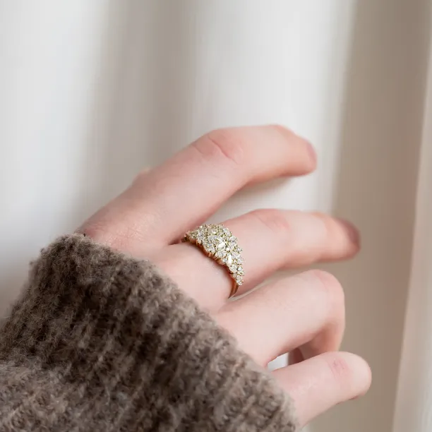 Angled view of the VALENTINA gold moissanite ring worn on a hand