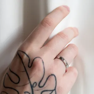 Diamond wedding ring from the TRADITIO pair worn on a hand