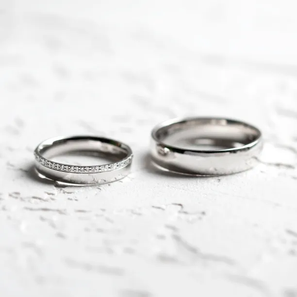 TRADITIO diamond wedding rings shown separately in a clear view