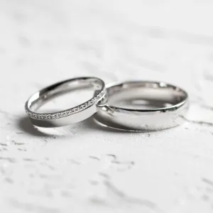 Diamond wedding rings TRADITIO, featuring a diamond-adorned ring and plain band