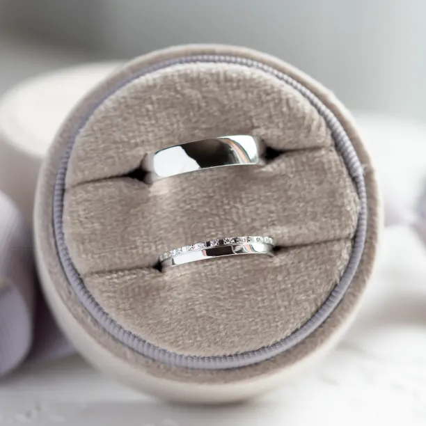TRADIZIONE wedding rings shown as a pair, with one diamond-set band