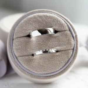 TRADIZIONE wedding rings shown as a pair, with one diamond-set band