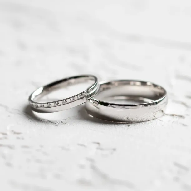 TRADIZIONE minimalist diamond wedding rings, one plain and one diamond-set band