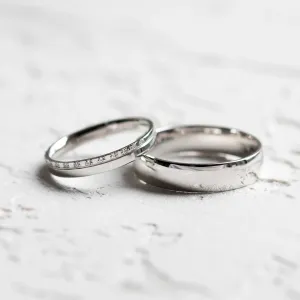 TRADIZIONE minimalist diamond wedding rings, one plain and one diamond-set band