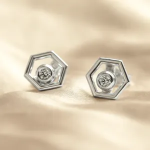 Close-up of white gold hexagonal earrings with removable gemstones