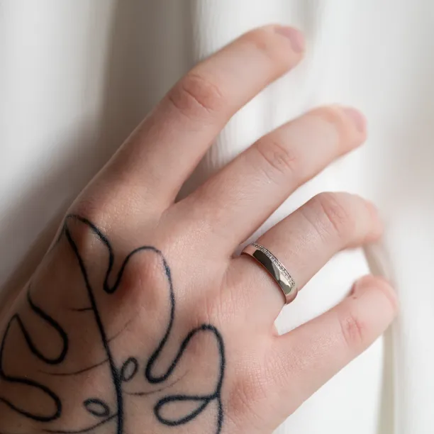 Diamond-set women's TRADITION wedding ring worn on a hand