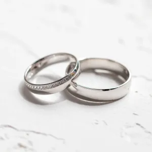 Angled view of TRADITION his and hers wedding rings
