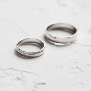 Separated TRADITION wedding rings, with the diamond-set women's ring in front