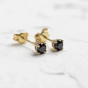 Angled view of black diamond stud earrings with their posts visible