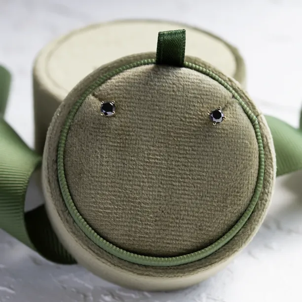 Pair of black diamond stud earrings shown from above