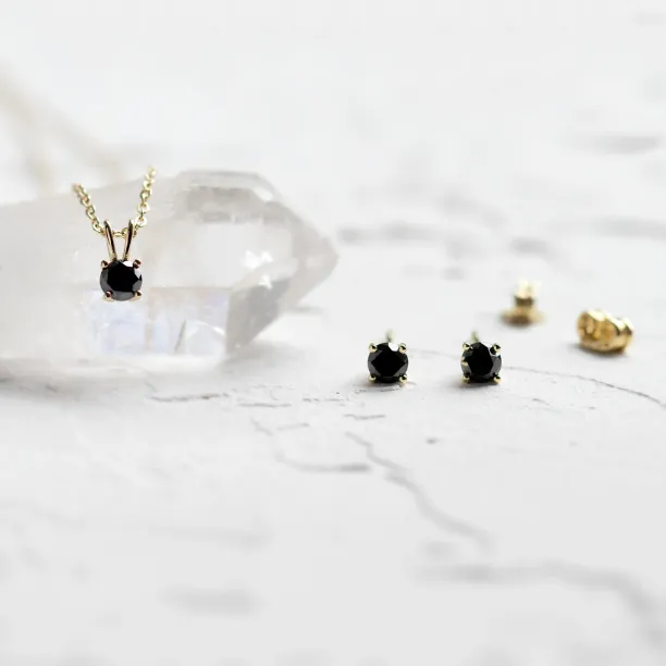 Black diamond stud earrings shown beside a matching pendant