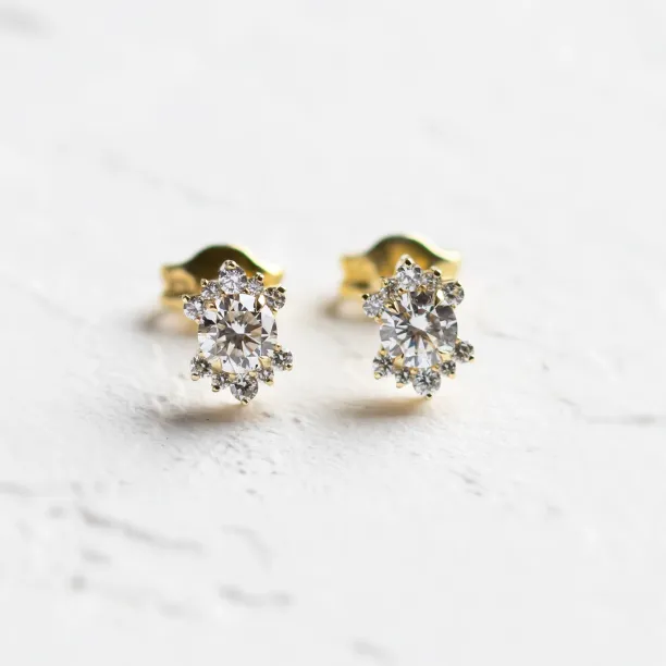 Close-up of AMORIS gold stud earrings with lab-grown diamonds