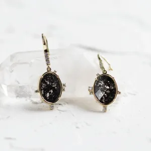 Angled view of MARIBEL vintage earrings with salt and pepper diamonds