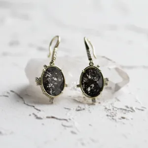 Close-up of MARIBEL gold earrings with oval salt and pepper diamonds and classic diamonds
