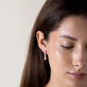 Close-up of a MARINA moissanite dangle earring on the ear