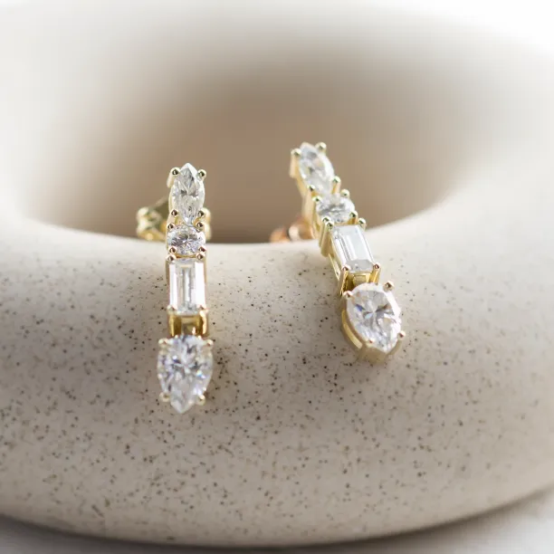 Angled view of the MARINA dangle moissanite earrings
