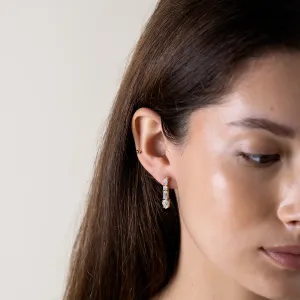 Close-up of a MARINA moissanite dangle earring worn on the ear