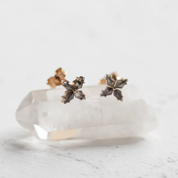 Angled close-up of the FLORIS salt and pepper diamond earrings