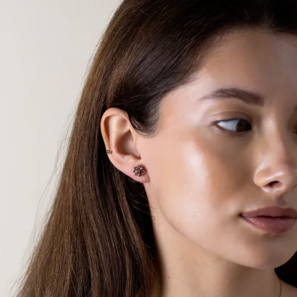 FLOWER floral earring with a salt and pepper diamond worn on the ear
