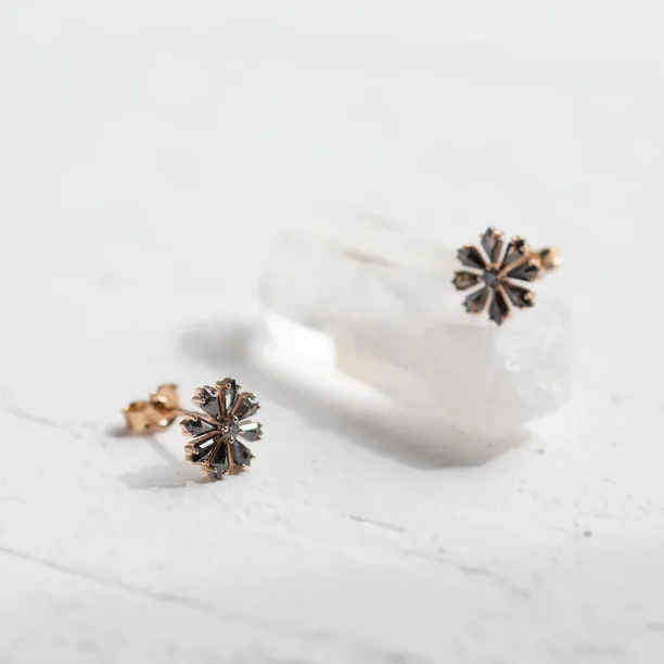 Angled view of FLOWER floral earrings with salt and pepper diamonds