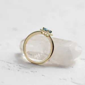 Angled detail of the MILLIE ring with a blue radiant-cut lab-grown diamond and white diamonds