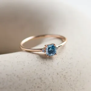 Angled view of the ARCTIS gold ring with a blue lab-grown diamond