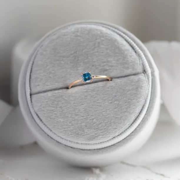 ARCTIS gold ring shown from above with a cushion-cut blue lab-grown diamond