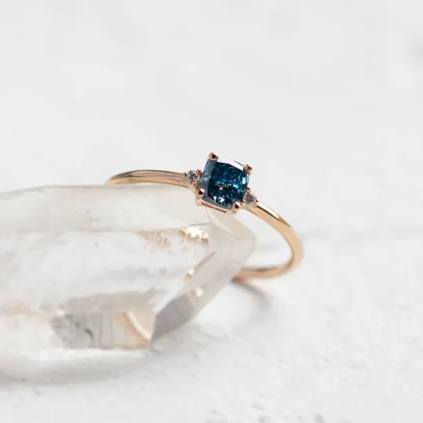 Close-up of the ARCTIS ring setting with a blue lab-grown diamond and white diamonds