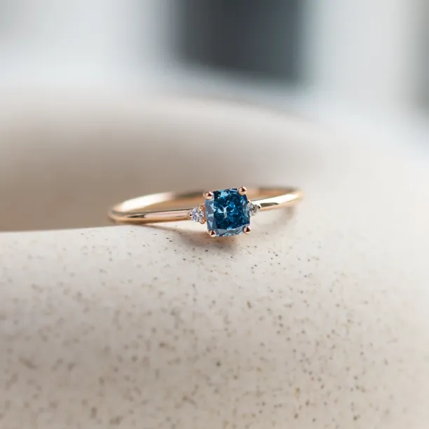 ARCTIS gold ring with a blue lab-grown cushion-cut diamond and white diamonds, close-up angled view