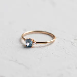Close-up of the ARCTIS gold ring with a cushion-cut blue lab-grown diamond