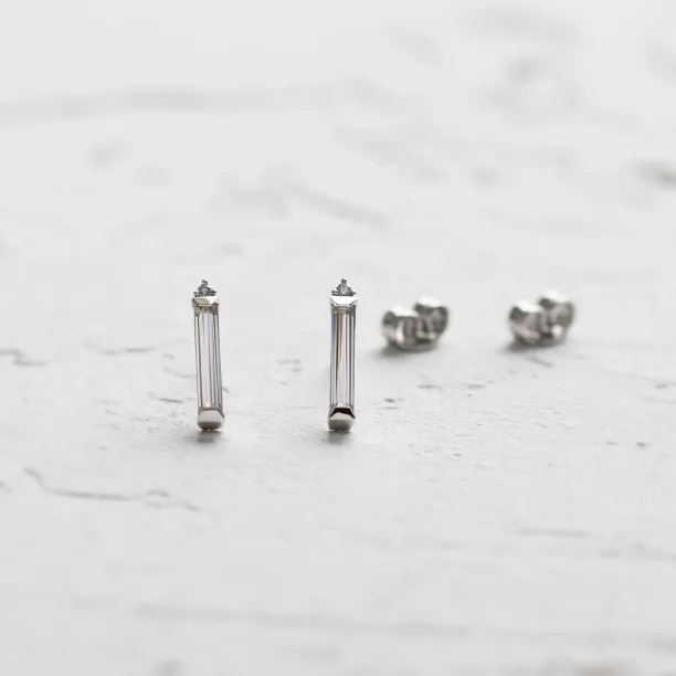 FELICIS moissanite and diamond earrings with their earring backs visible