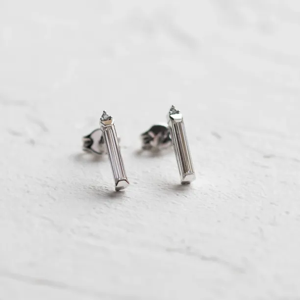 Angled view of FELICIS moissanite and diamond earrings
