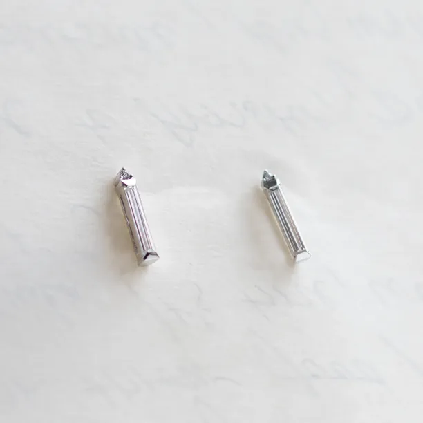 Angled pair of FELICIS moissanite and diamond earrings