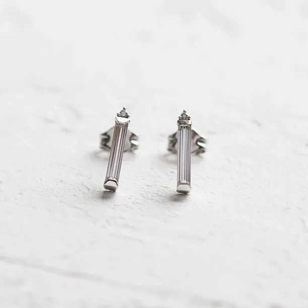 Close-up of FELICIS moissanite and diamond stud earrings