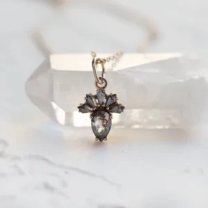 Close-up of the LONIA gold pendant with salt and pepper diamonds