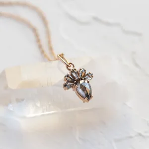 Angled close-up of the LONIA salt and pepper diamond pendant