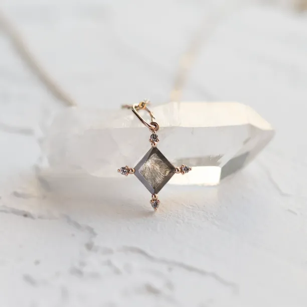 CRESSIDA necklace pendant close-up highlighting the salt and pepper diamond inclusions